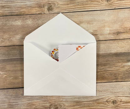 White envelope with a card on a wooden surface