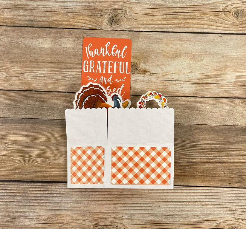 Thanksgiving-themed card with a turkey cutout on a wooden background