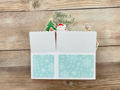 Christmas-themed card with snowflake design on a wooden surface