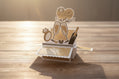 Pop-up card with 'Just Married' text and wedding-themed elements on a wooden surface