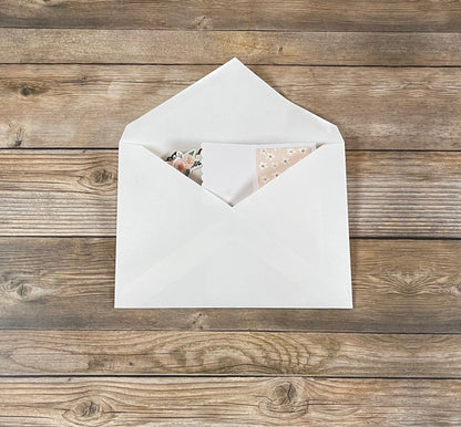 White envelope with a card on a wooden surface