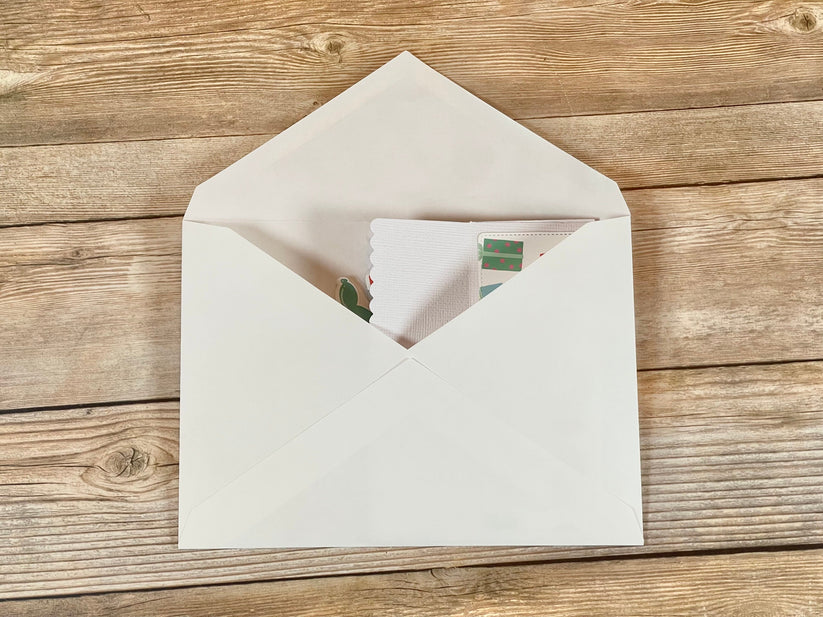 White envelope with a letter on a wooden surface