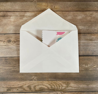 White envelope with a card on a wooden surface
