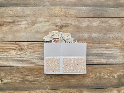 Card with 'Just Married' text on a wooden surface