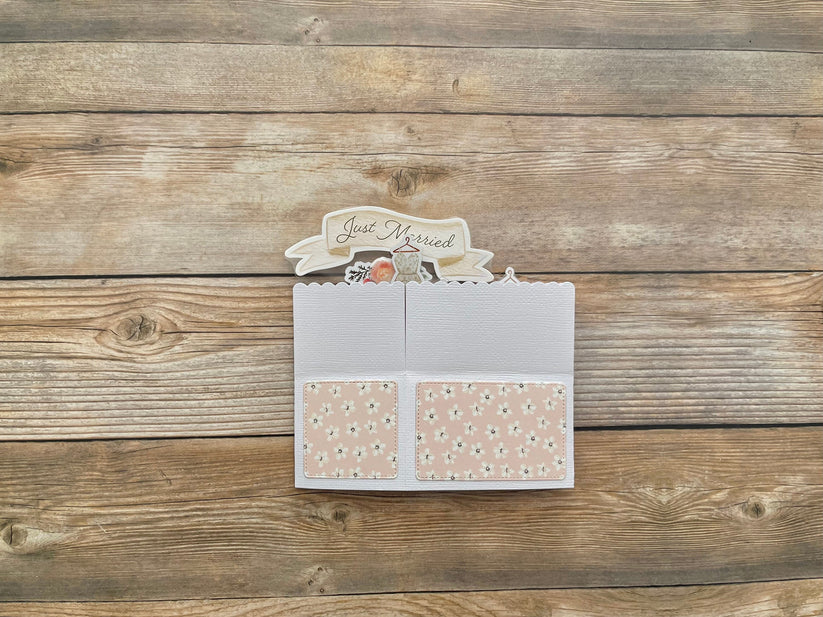 Card with 'Just Married' text on a wooden surface