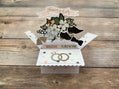 Wedding-themed pop-up card with 'Bride' and 'Groom' text on a wooden surface