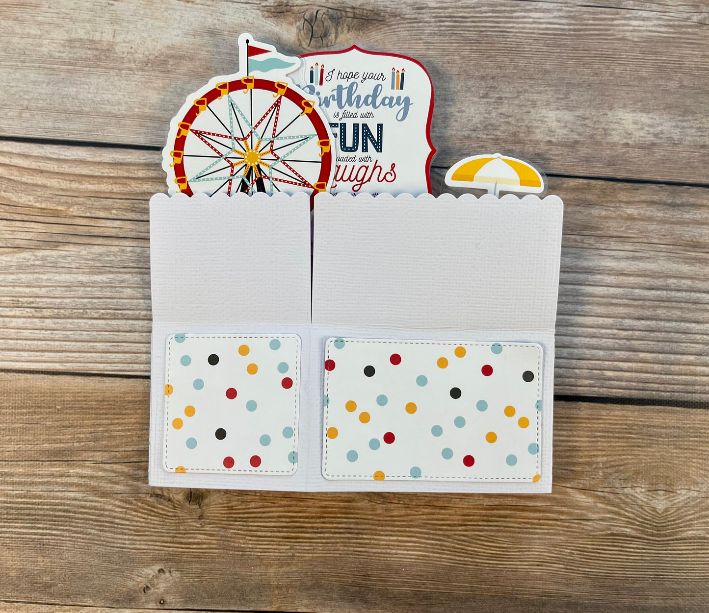 Folded pop-up card with carnival theme.  Outside has multicolored polka dots.
