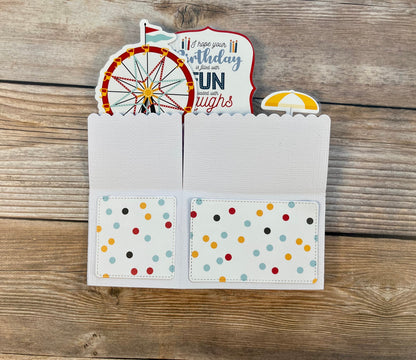 Folded pop-up card with carnival theme.  Outside has multicolored polka dots.