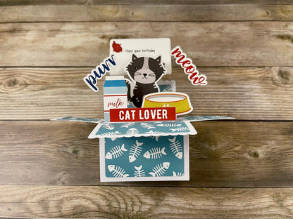 Pop-up card for cat lovers on a wooden surface