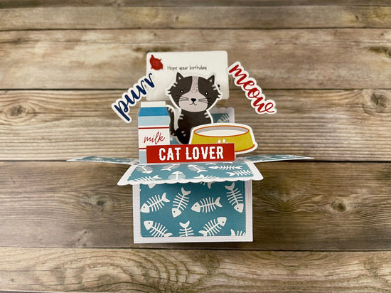 Pop-up card for cat lovers on a wooden surface
