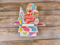 Colorful birthday pop-up card on a wooden surface
