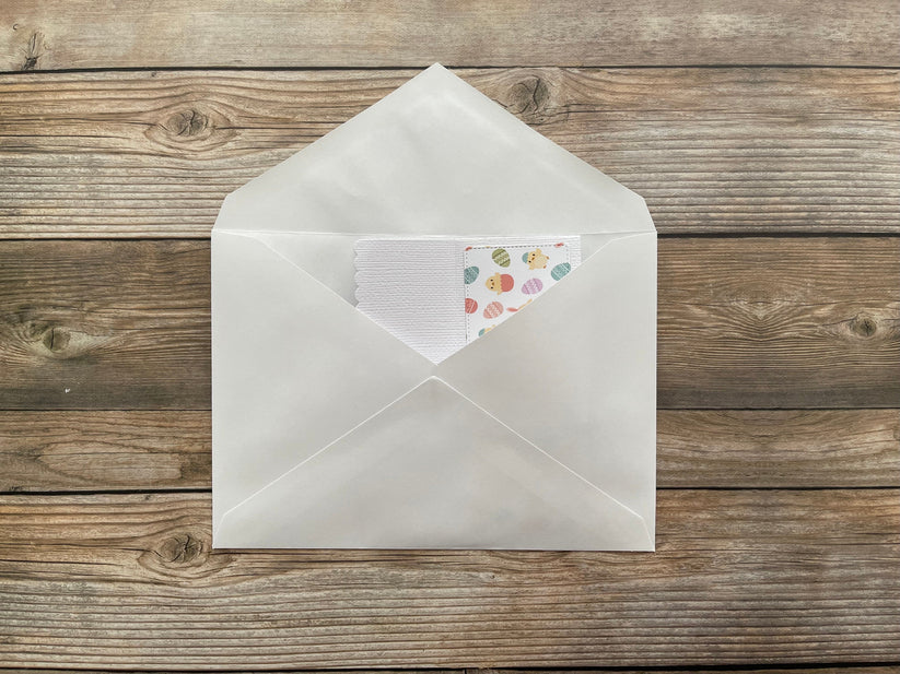 Open envelope with a letter inside on a wooden surface
