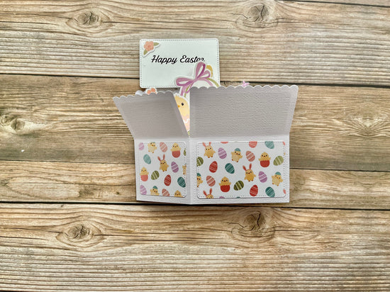 Easter-themed card with colorful eggs and a 'Happy Easter' message on a wooden surface.