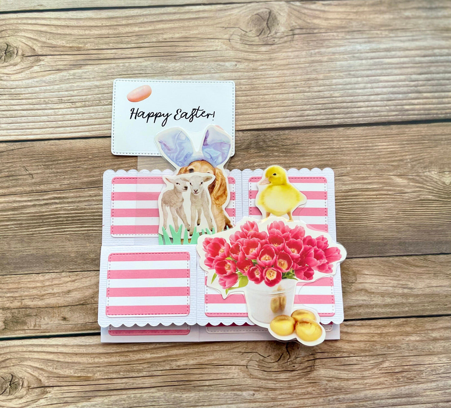 Easter-themed card with cartoon animals and flowers on a wooden surface