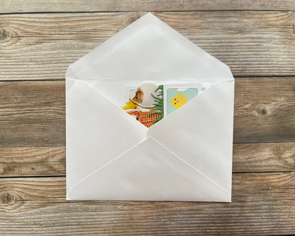 White envelope with a colorful card on a wooden surface
