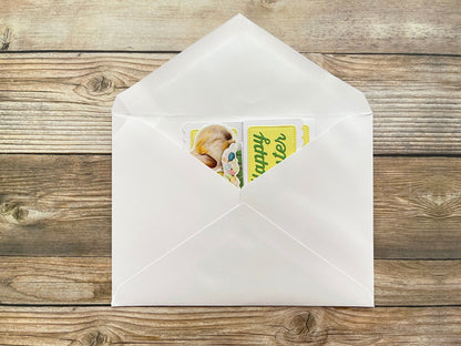 White envelope with a card inside on a wooden surface