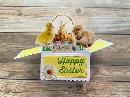 Easter-themed box style pop-up card with a duck, rabbit, and basket on a wooden background