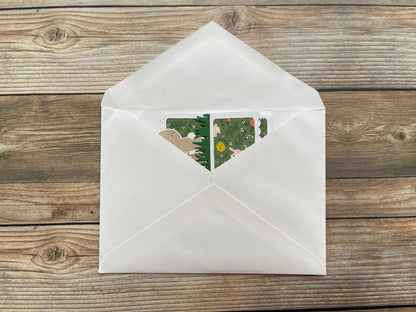 White envelope with a floral design on a wooden surface