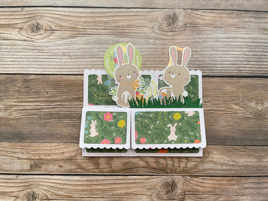 Card with rabbit illustrations on a wooden surface