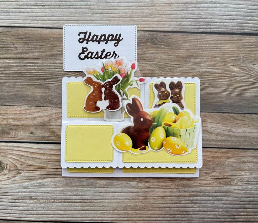 Easter-themed card with chocolate bunnies, eggs, and flowers on a wooden surface