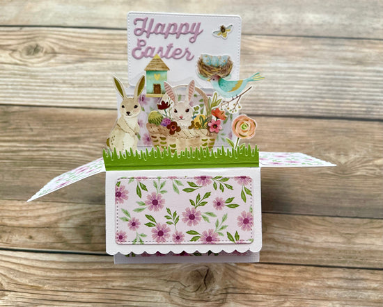 Pop-up Easter card with rabbit, chick, and flowers on a wooden background