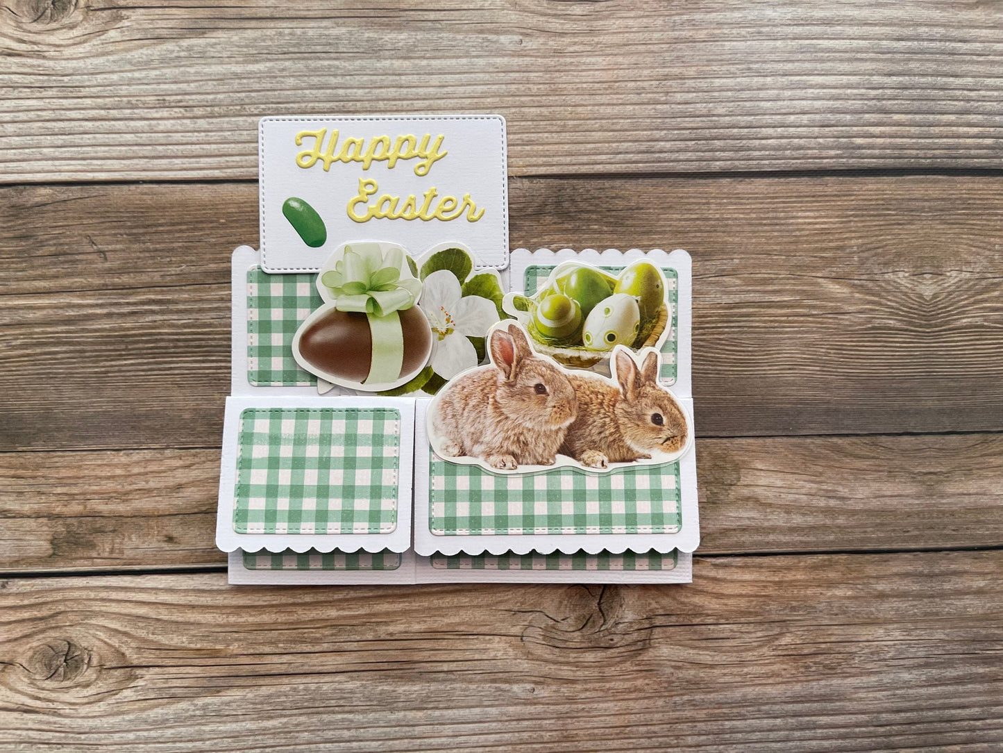 Easter card with bunnies and eggs on a wooden surface