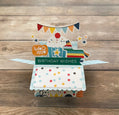 Colorful birthday card with a pop-up design on a wooden surface