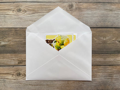 White envelope with a colorful card on a wooden surface