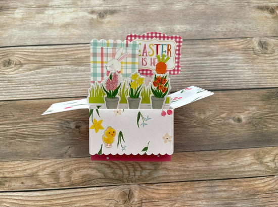 Easter-themed pop-up card on a wooden surface