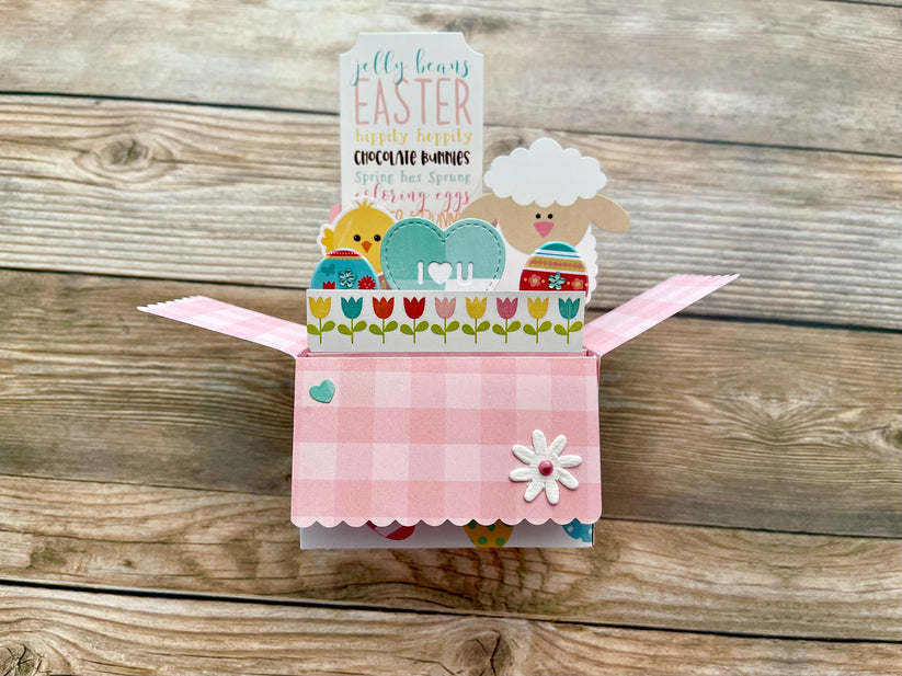 Decorative Easter card with a sheep design on a wooden surface