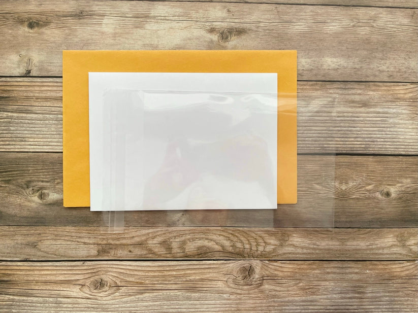 Clear plastic sheet on a wooden surface with a yellow border