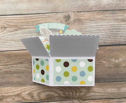 Open card with colorful polka dot design on a wooden surface