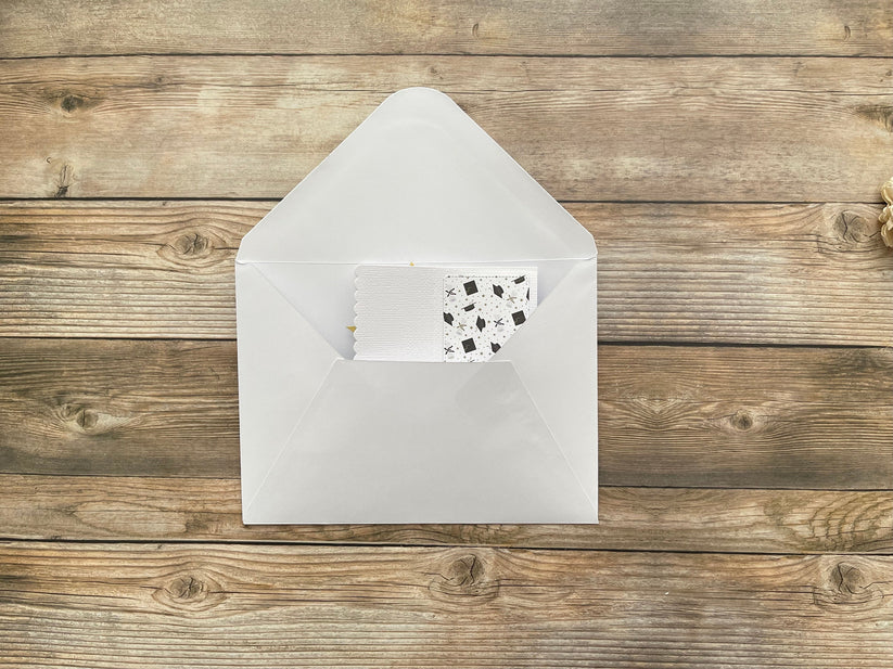 White envelope with a small card on a wooden surface