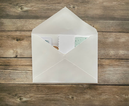 White envelope with a letter on a wooden surface