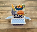Pop-up card with grill, burger, and 'You're #1 Dad' text on a wooden background
