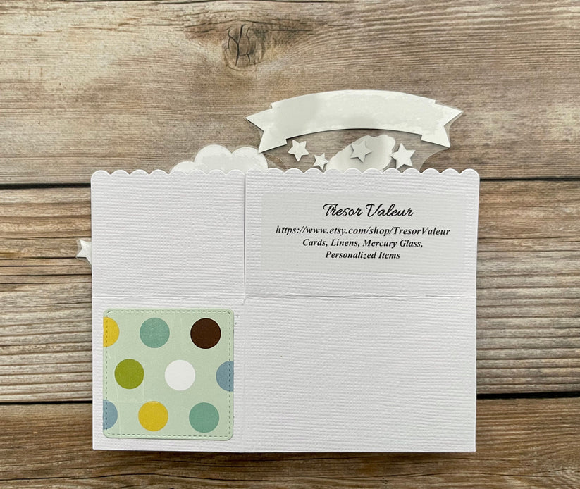 White card with a colorful polka dot design on a wooden surface