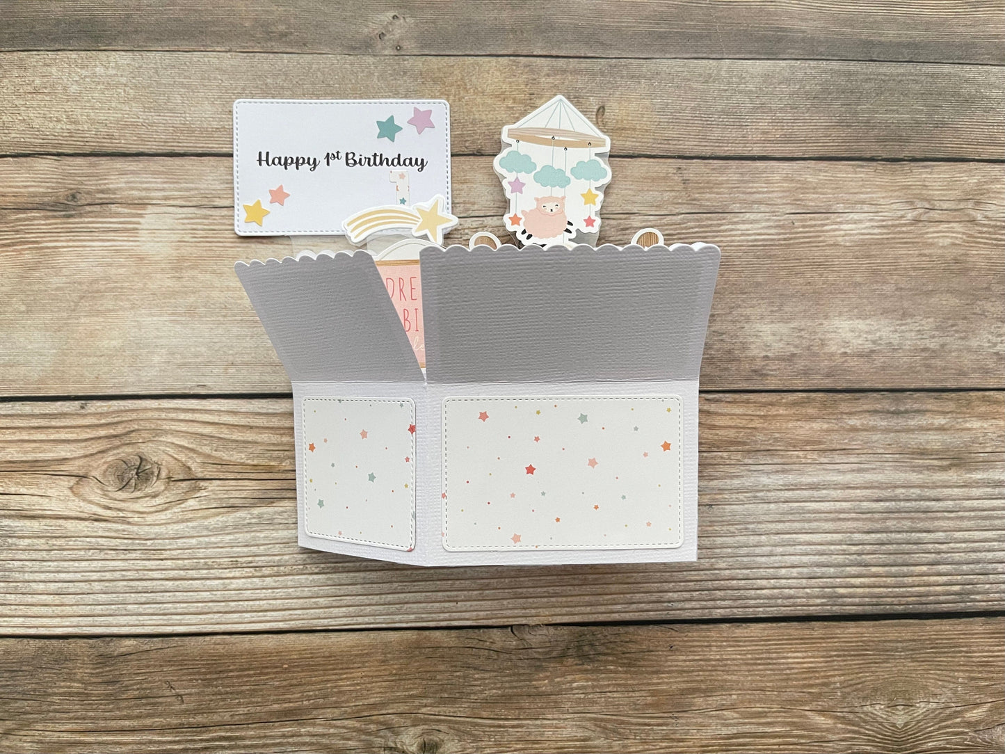 Folded pop-up card with decorative elements on a wooden surface