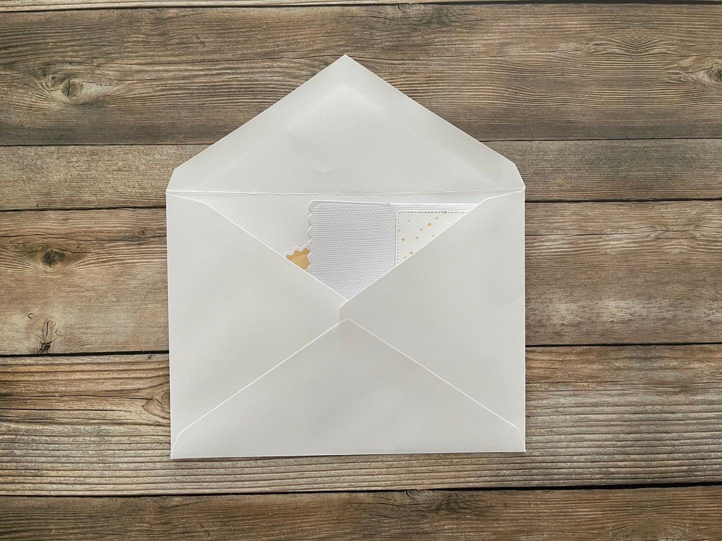White envelope with a letter on a wooden surface