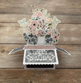 3D floral birthday card on a wooden surface