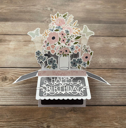 3D floral birthday card on a wooden surface