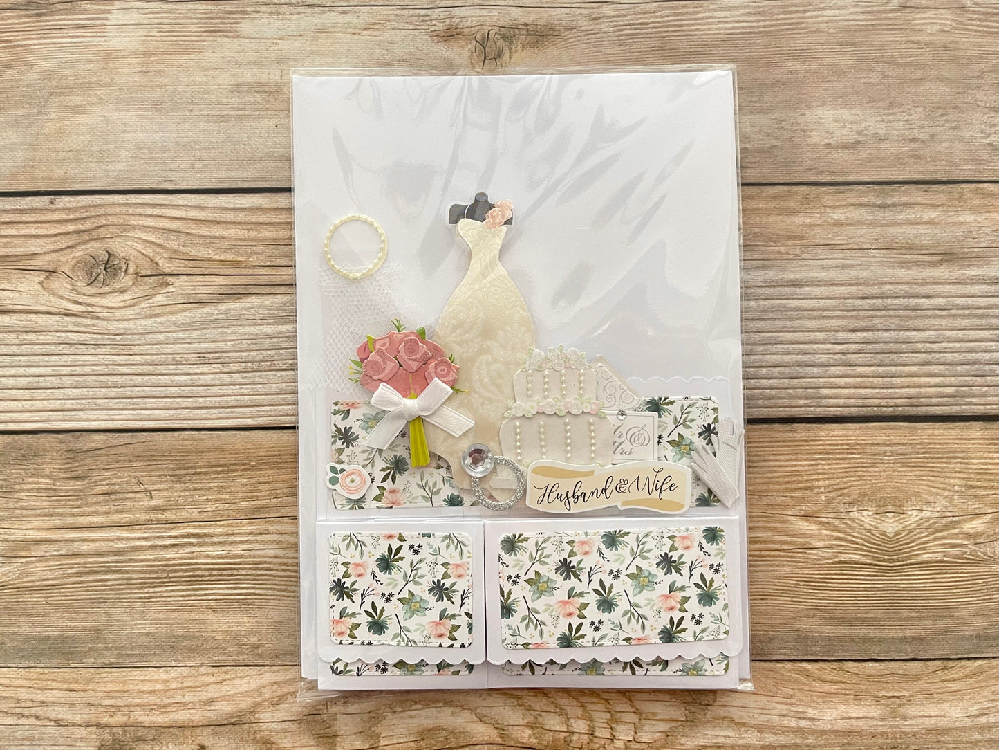 Decorative card with floral patterns and text on a wooden surface