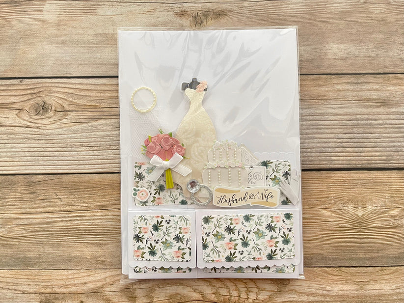 Decorative card with floral patterns and text on a wooden surface