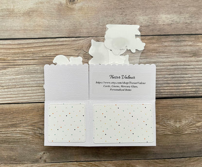 White card with text and patterns on a wooden surface