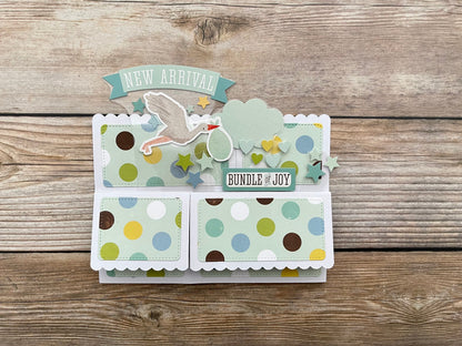 Folded 3D box pop-up card with polka dots and text on a wooden surface