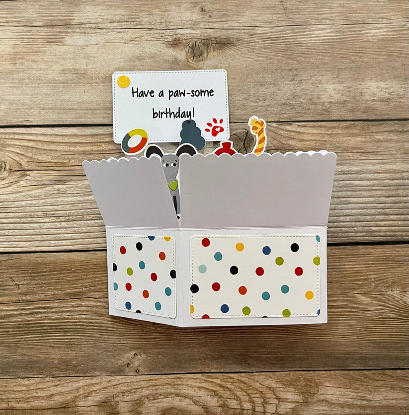 Polka dot card holder with a small card on a wooden surface