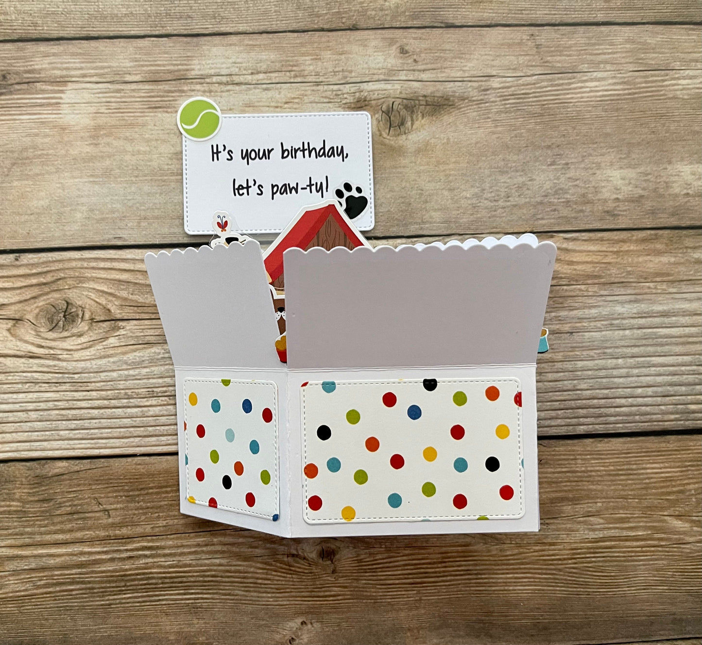 Polka dot card with birthday message on a wooden background