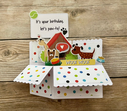 Dog-themed birthday card with colorful polka dot interior on a wooden background