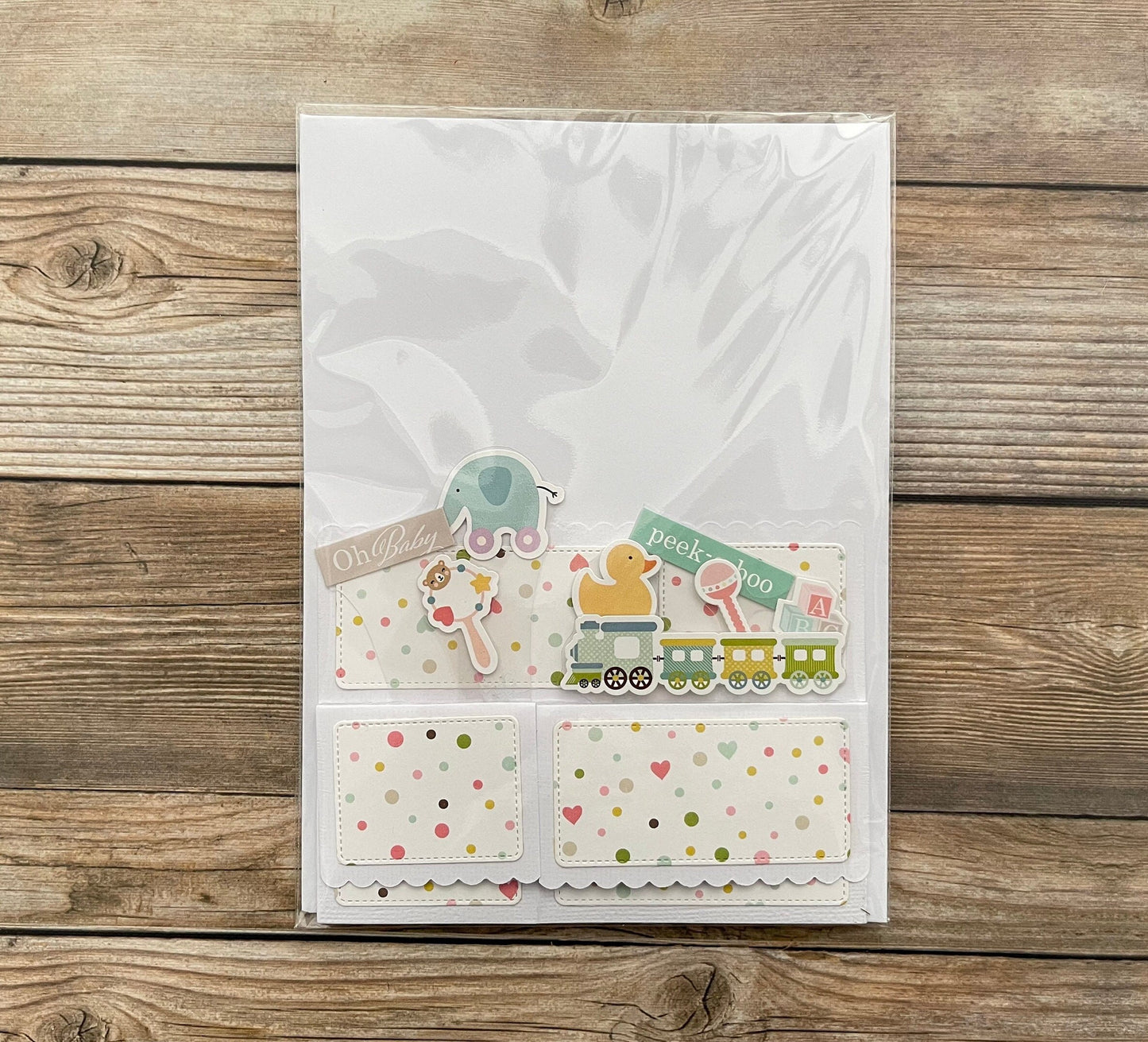 3D box pop-up baby card shown in cellophane package.