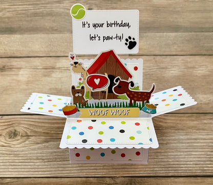 Dog-themed birthday card with open design on a wooden surface