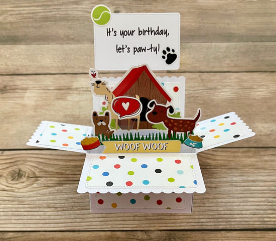 Dog-themed birthday card with open design on a wooden surface